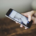 user is surfing social network on mobile phone