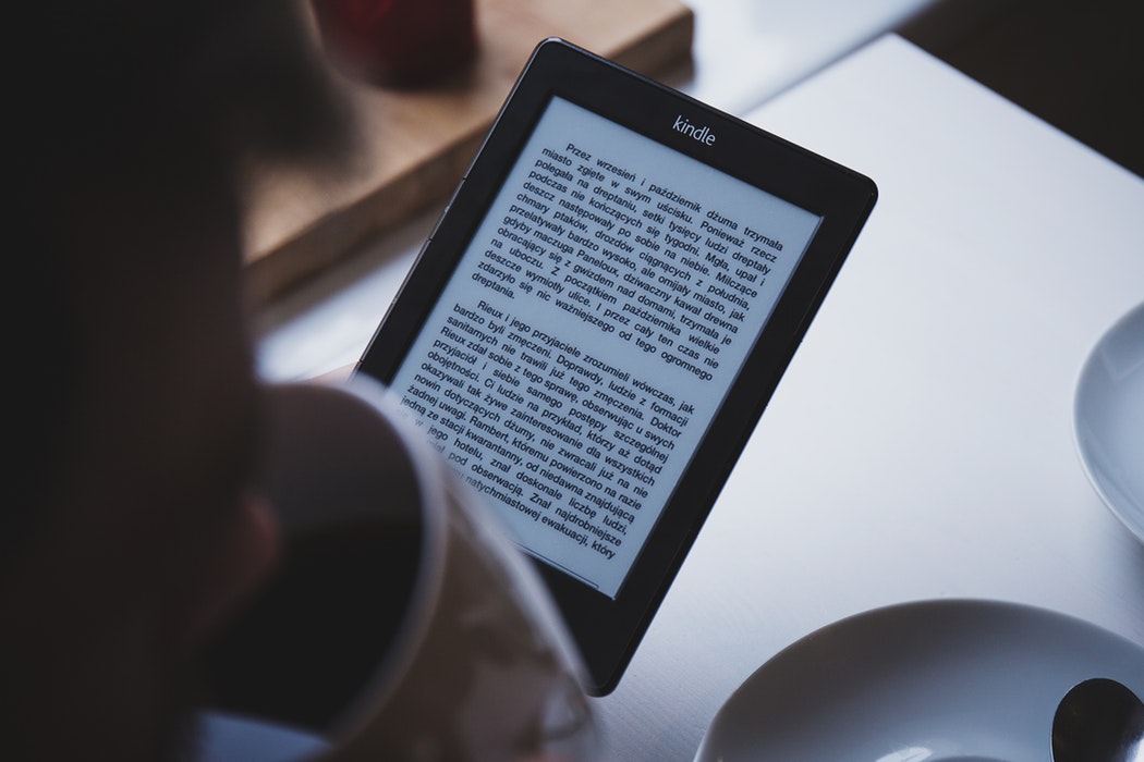 man telling story by looking at tablet 