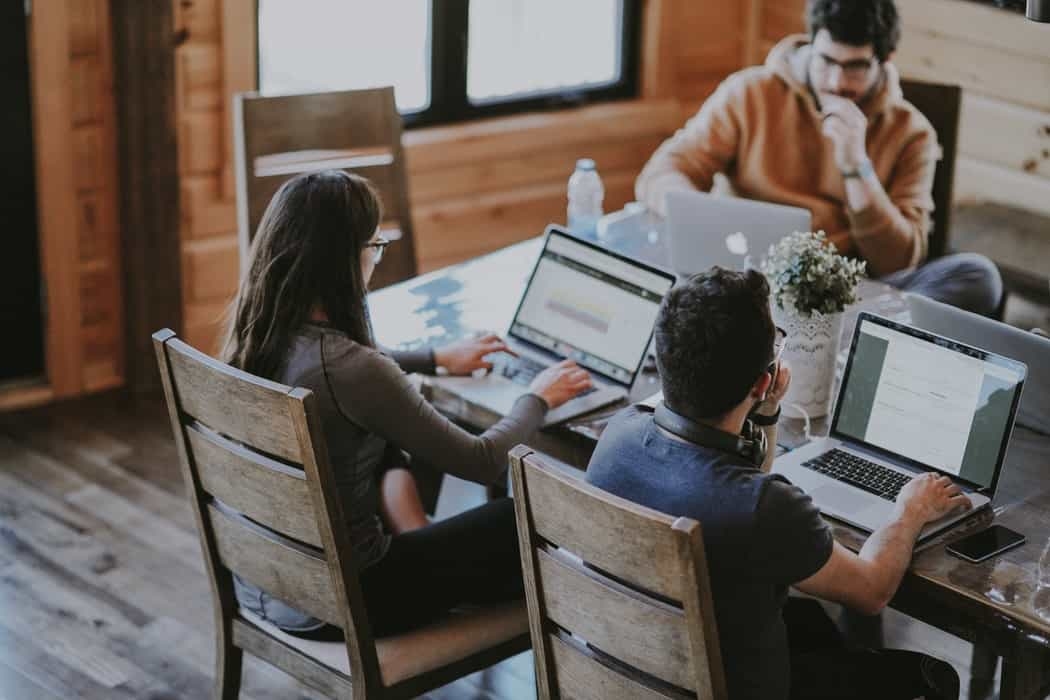 Everyone in the room is focused on working on the computer