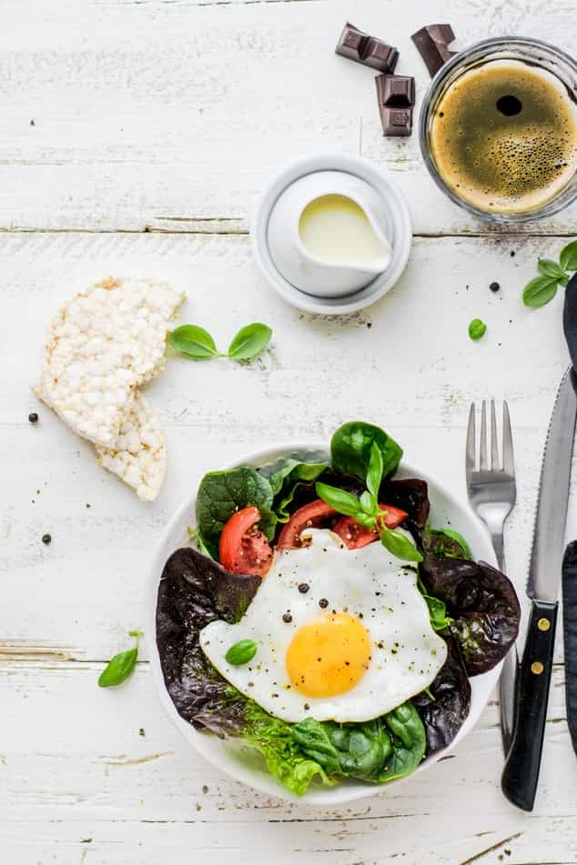 Breakfast on the table includes salad, cake and coffee