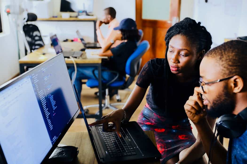 Woman and man discussing work on computer