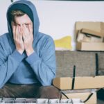 Image of a man tired of not having a balance between work and life