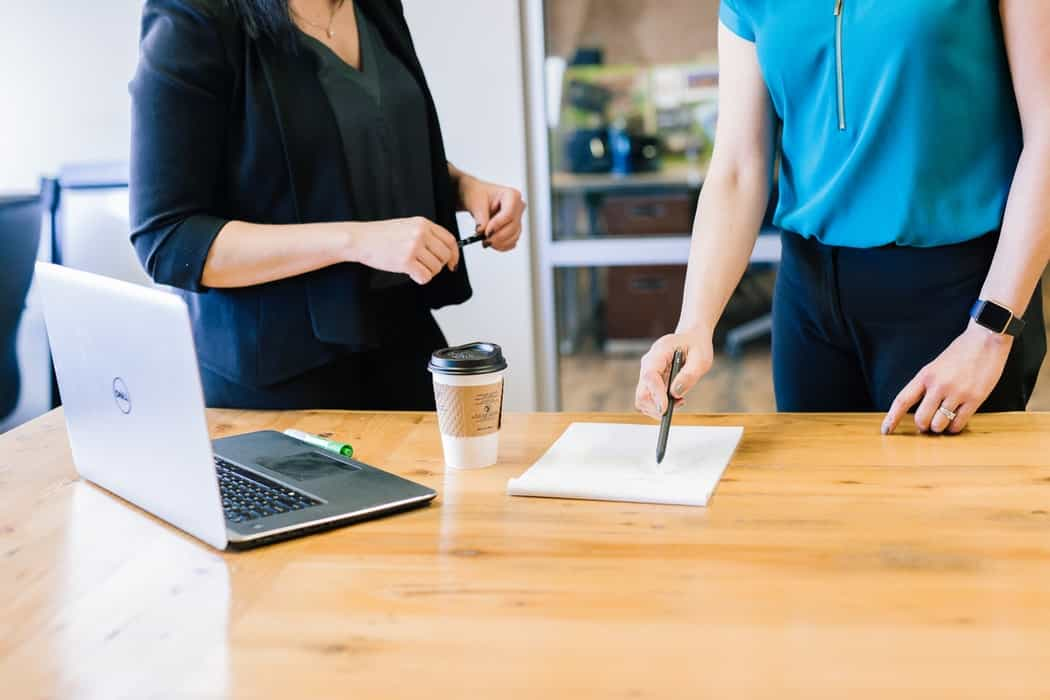 2 women are discussing work together